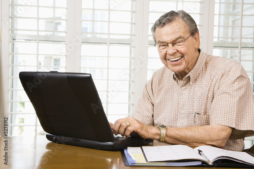 Mature man with laptop.
