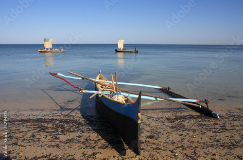 Malagasy fishermen and their outrigger canoes photo