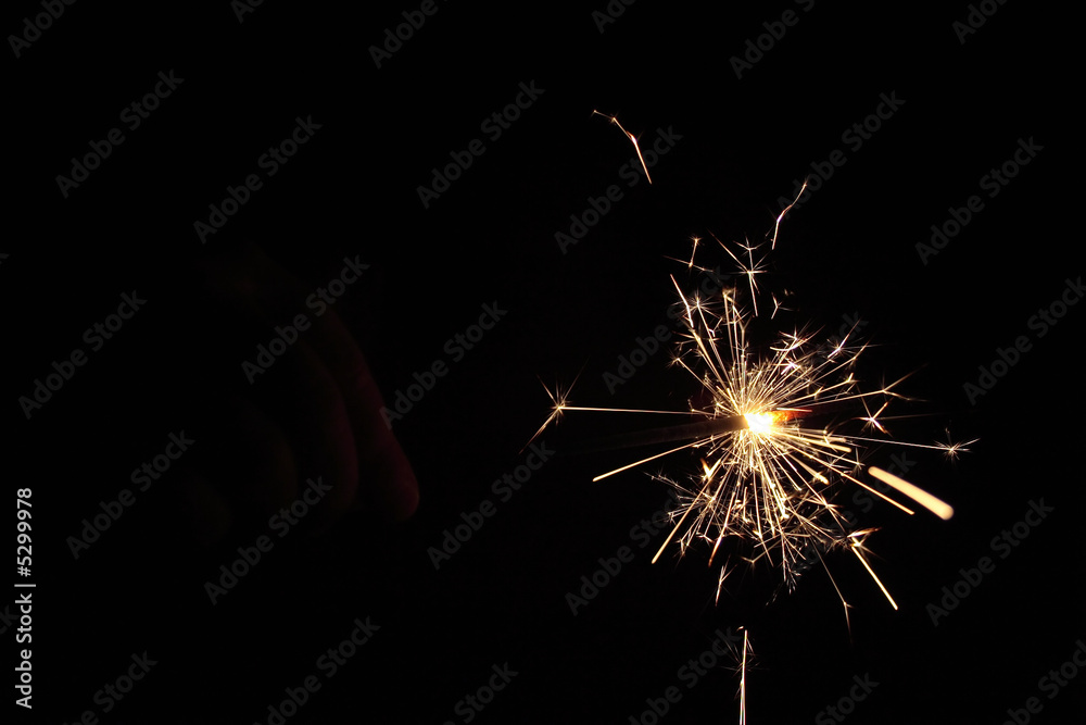 hand in dark with fire-cracker