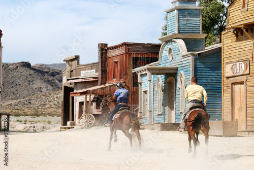 Two cowboys in a traditional American western town