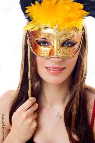 Attractive woman wearing gold carnival mask