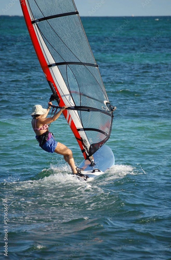 Obraz premium Woman on a Sailboard