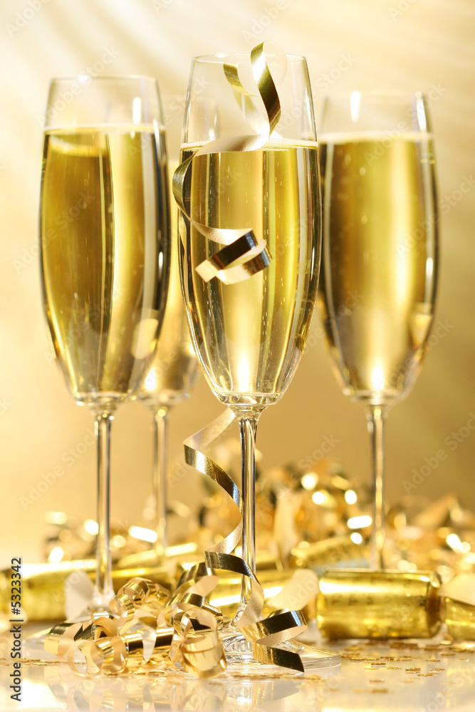 Glasses of golden champagne with rays of light Glasses of golden champagne with rays of light
