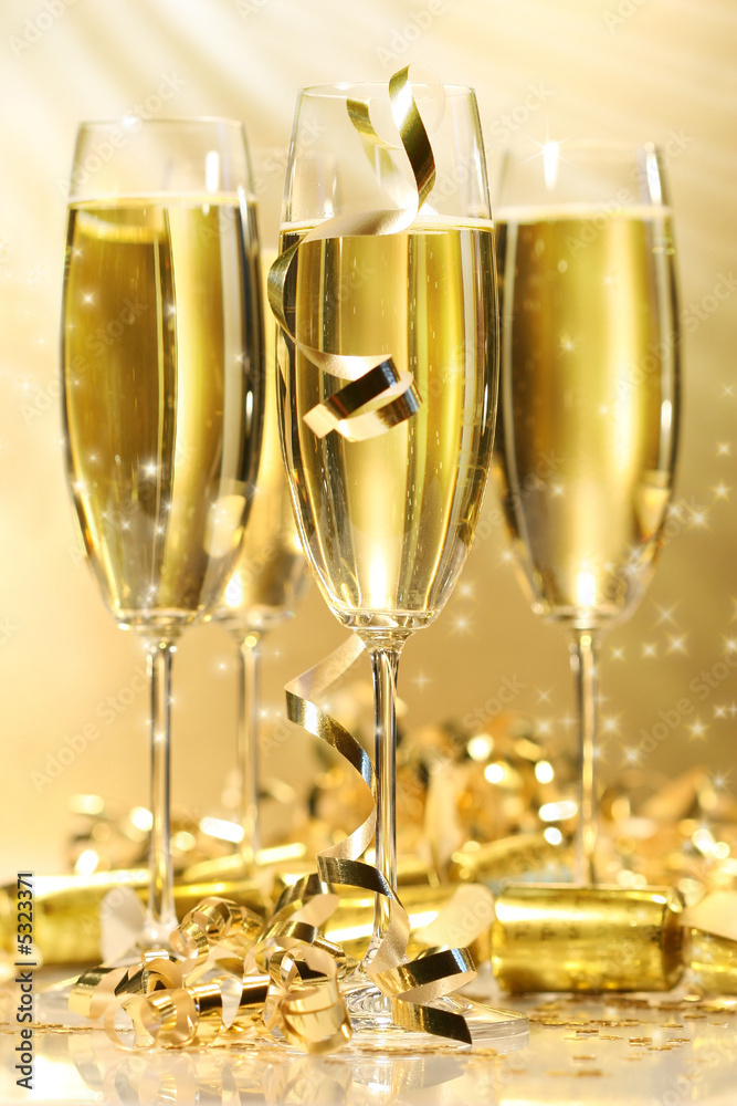 Glasses of golden champagne with stars Glasses of golden champagne with stars