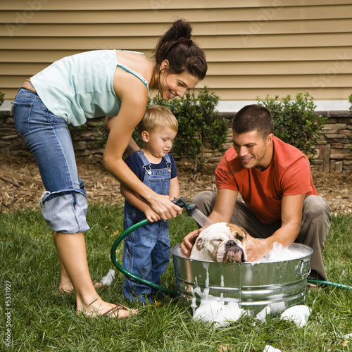 Family giving dog a bath. photo