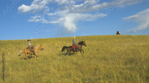 Fototapeta Naklejka Na Ścianę i Meble -  Cowboys riding to meet supply arrival. 