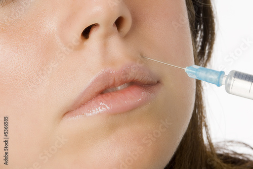 Portrait of fresh and beautiful woman getting botox injection photo