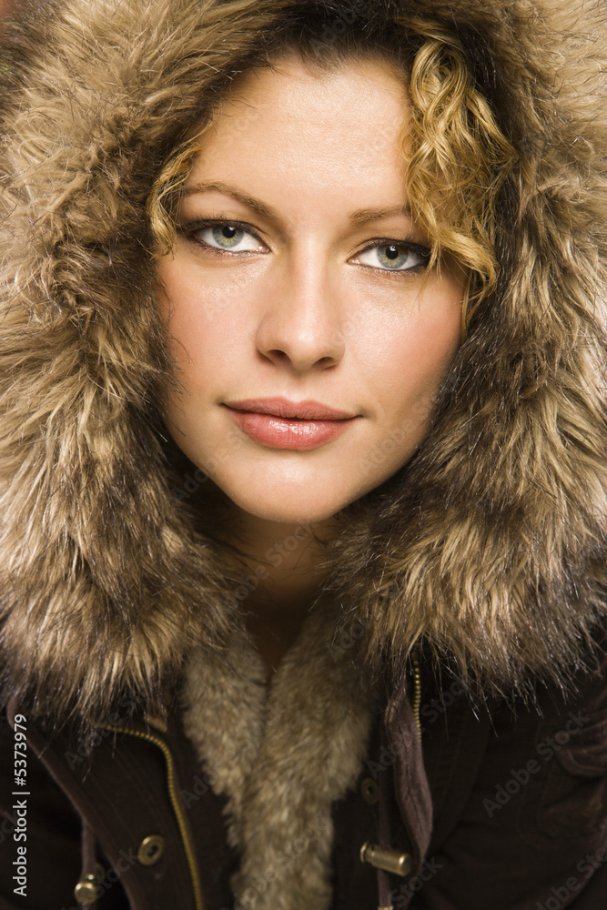 Caucasian woman wearing coat with fur hood. Caucasian woman wearing coat with fur hood.