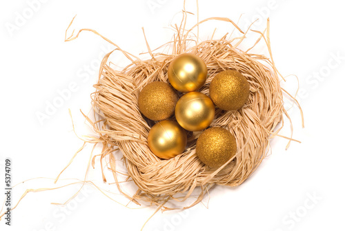 Basket with gold eggs and a New Year's toy