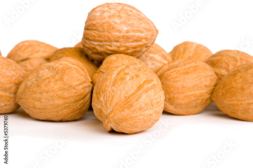 Walnuts on white background, focus on front nut