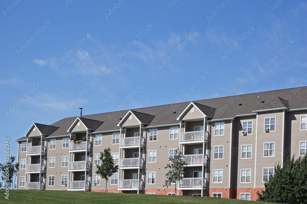 A new apartment building surrounded by green space.