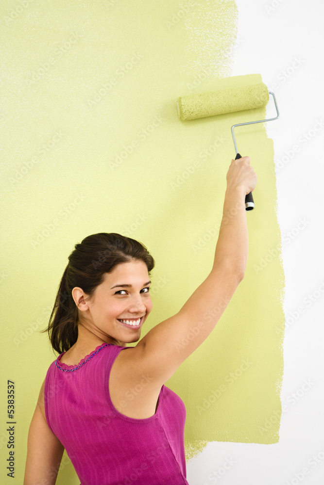 Smiling woman painting. Smiling woman painting.