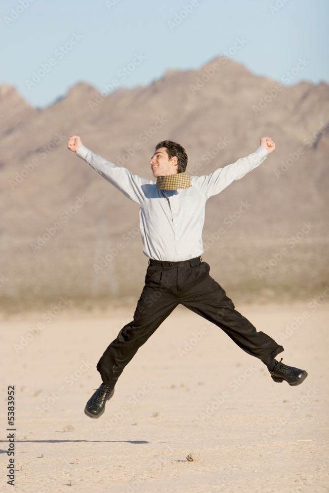 Happy businessman jumping in air Happy businessman jumping in air