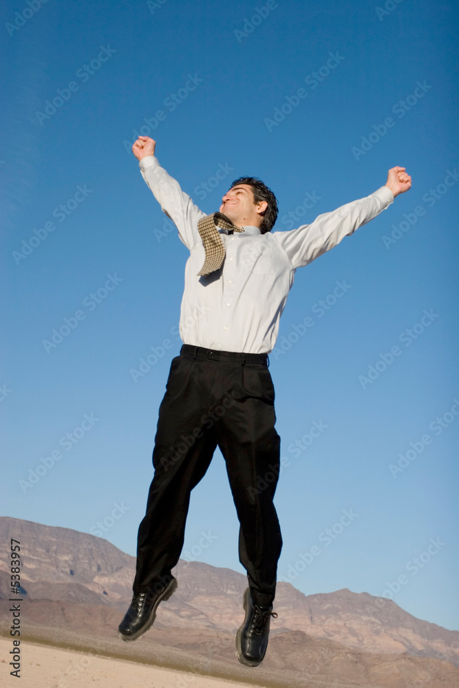 Happy businessman jumping in the air Happy businessman jumping in the air