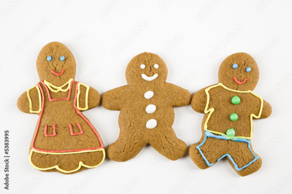 Three male and female gingerbread cookies holding hands. Three male and female gingerbread cookies holding hands.