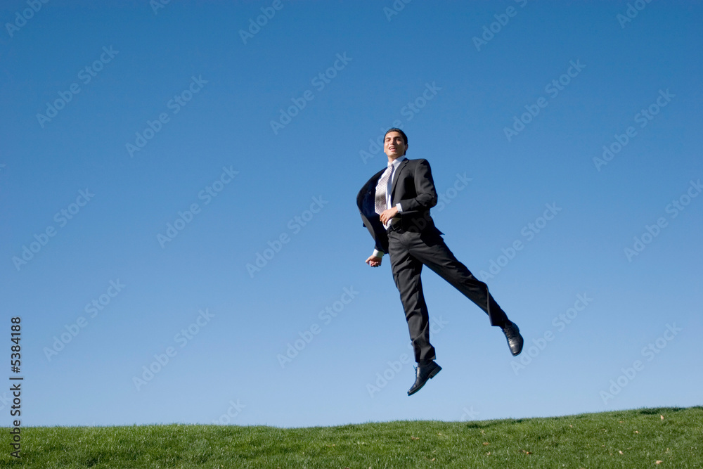 Businessman jumping in the air