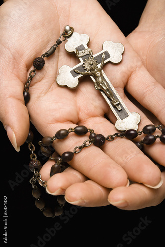Hands holding rosary.