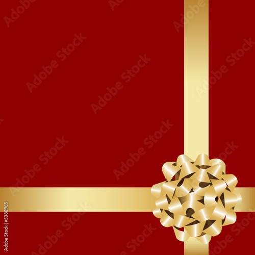 Golden gift bow with ribbon on the red background.