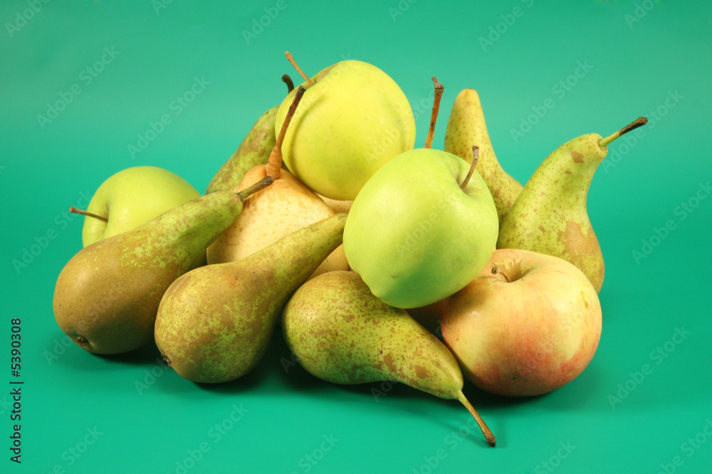 Apples and pears on a green background.