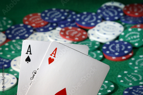 Pocket Aces, with poker chips in the background.