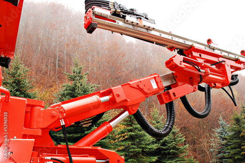 orange heavy duty mine drill in wood