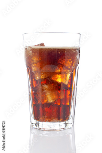 A soda drink glass with ice cubes, reflected on white background