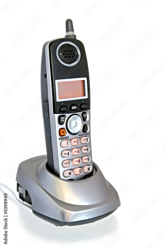 A cordless telephone in its cradle, isolated on white. A cordless telephone in its cradle, isolated on white.