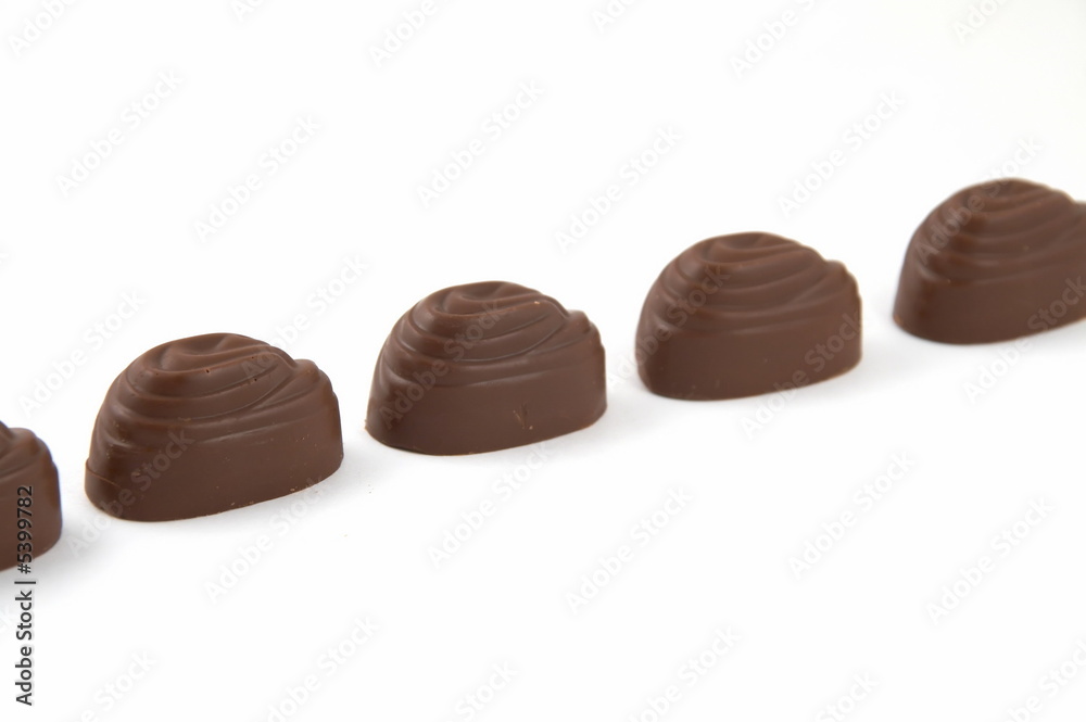 Sweets chocolate with a stuffing, on a white background Sweets chocolate with a stuffing, on a white background