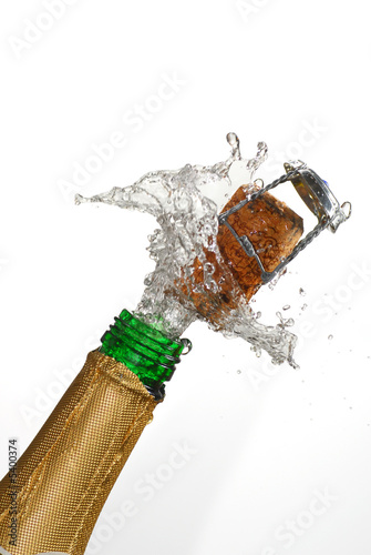Close up of champagne cork popping with white background