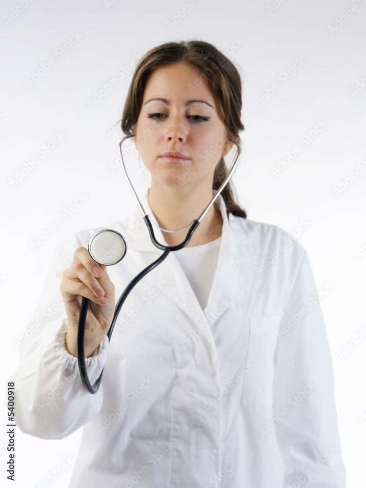 cute brunette in white medical gown focus on the stethoscope cute brunette in white medical gown focus on the stethoscope