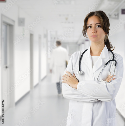 cute brunette in medical gown  and a stethoscope in an hospital