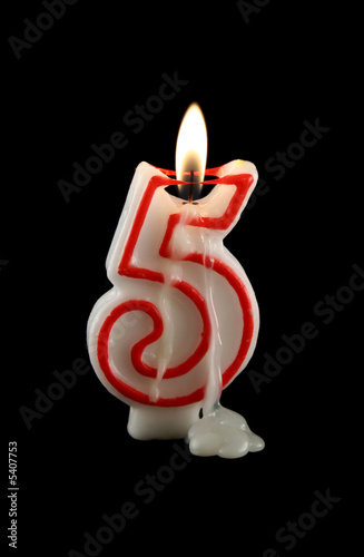 Burning number five candle with dripping wax.