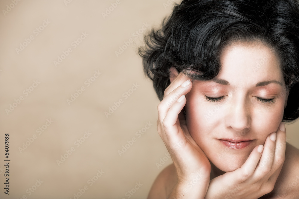 Face of a smiling woman with black curly hair, in her mid 30s Face of a smiling woman with black curly hair, in her mid 30s