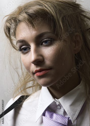 Beautiful girl with tie. She looks forward