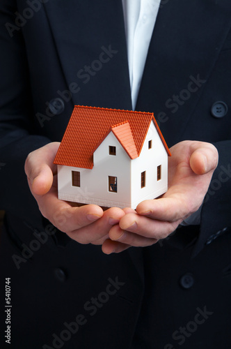 Hand of the businessman with the house