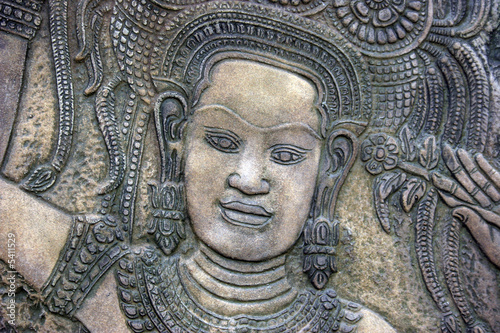 Traditional Thai stone carving on a wall - travel and tourism.