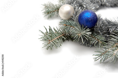 White and blue bulbs covered with snow and spruce thigs
