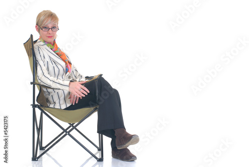 Attractive blond young businesswoman in director chair, 