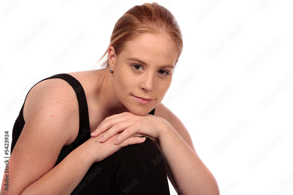 Young model in gym clothes resting on knee Young model in gym clothes resting on knee