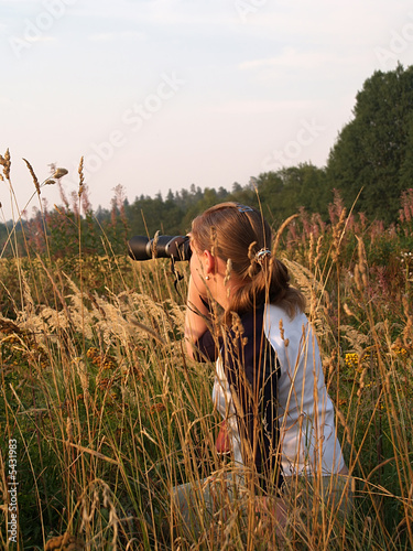 Young girl watches birds near the river, close-up