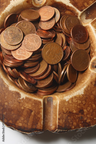 many Euro coins in ashtray