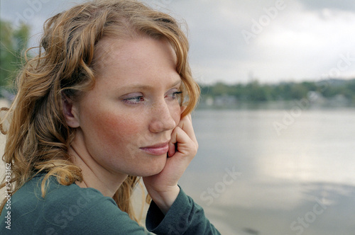 young red-haired woman on deserted beach © Photobank