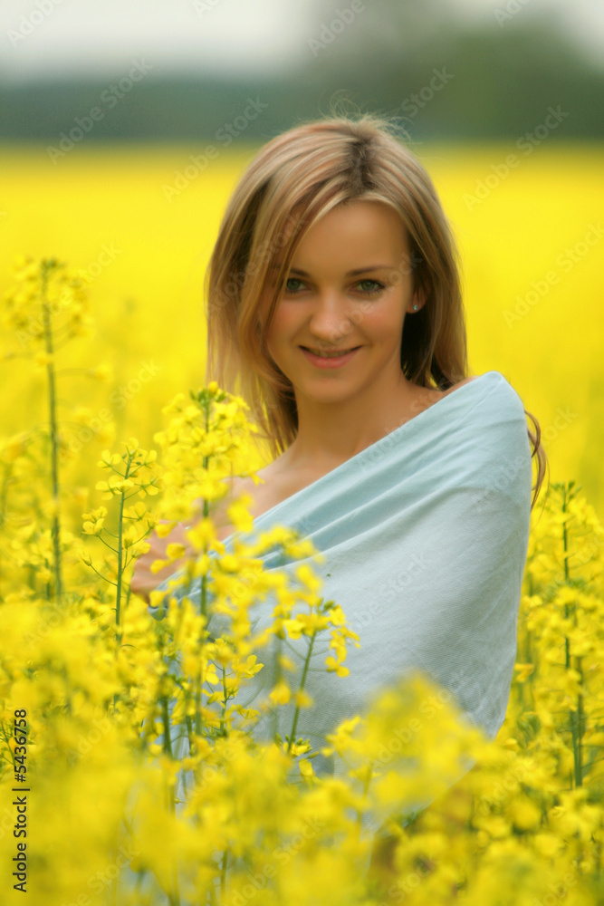 Girl stands in yellow flower field - very cute portrait Girl stands in yellow flower field - very cute portrait