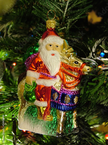 old fashoned Santa doll on the chrismas tree photo