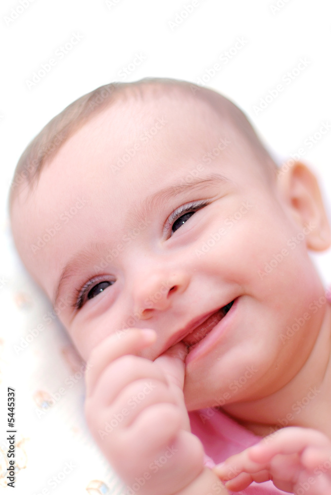 Baby Smiling with the hand on the mouth . Baby Smiling with the hand on the mouth .