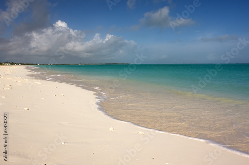 turquoise sea lapping on beach with blue sky © Robert Hackett