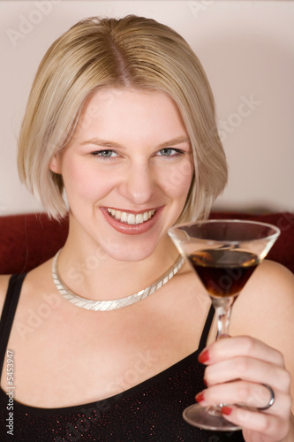 blonde woman holding a cocktail glass