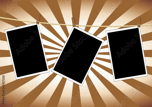 Photos hanging to dry on a rope over grunge background
