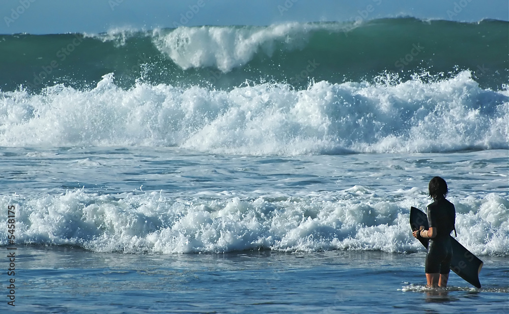 Girl with a bodyboard and dangerous ocean waves. Girl with a bodyboard and dangerous ocean waves.