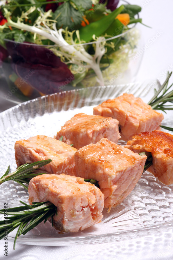 Salmon grilled on the rosemary skewers with vegetables